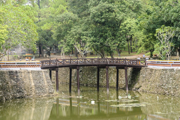 Fototapeta na wymiar bridge in the pond inside the complex of the mausoleum of the emperor Tu Duc in Hue, Vietnam.