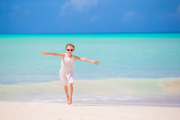 Fototapeta na wymiar Adorable little kid at beach during summer vacation