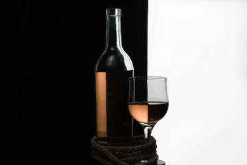 A bottle and a glass of white wine.