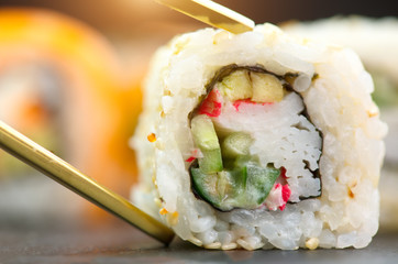 Sushi rolls. Japanese food in restaurant. Sushi roll set california with salmon, vegetables, flying fish roe and caviar closeup