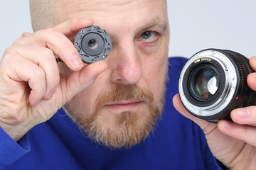 man shows part of the diaphragm of the camera lens