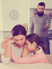 Father lecturing wife and daughter