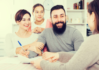 Parents signing property papers