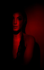 sexy fiery girl in red. Portrait of a beautiful sexy girl in red  background.