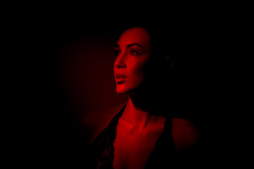 sexy fiery girl in red. Portrait of a beautiful sexy girl in red  background.