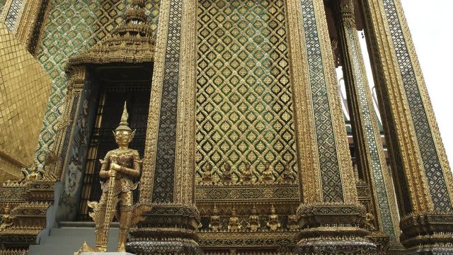 a gilded statue at thewat phra kaew temple complex in bangkok, thailand