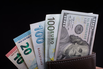 Hand holding American dollar  isolated on black background