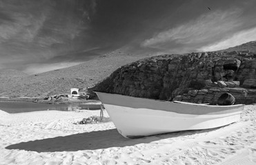 Small fishing boat / ponga at Punta Lobos beach on the coast of Baja California Mexico BCS - black and white