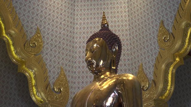 close up side on shot of the solid gold buddha at wat  traimit temple in bangkok, thailand