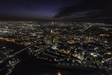 Fototapeta na wymiar Night aerial view towards urban downtown buildings and streets in Los Angeles California.