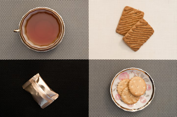 Cup of tea on the black and white, candys and biscuits. Classic strict style