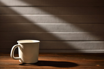Coffee cup on old wooden background