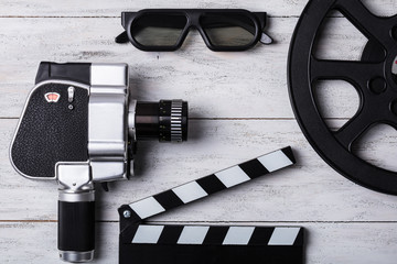 Elevated View Of Movie Camera, Film Reel And Clapper Board