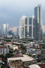 Fototapeta na wymiar Aerial view of a residential district, mixing low rise houses and luxury condominium towers in Jakarta