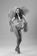 Young dancer in bikini and suit with feathers