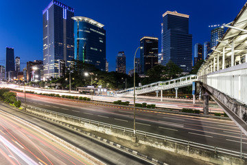 Traffic rushing in Jakarta business district at night in Indonesia capital city