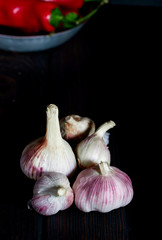 Aromatic garlic on a dark table with red pepper