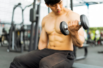 Fototapeta premium strong fitness man posing muscular body and doing exercises for bodybuilder in the gym, fitness concept, sport concept