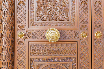 Highly decorated wood door at a mosque in the Middle East 