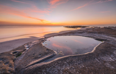 colorful sunset seascape with natural coastal rocks at Kudat Sabah Malaysia. 