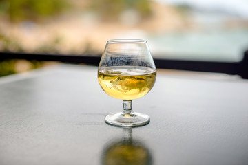 Whiskey with ice in a glass on the table