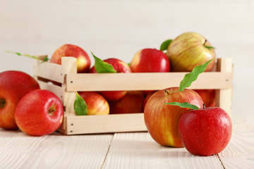 Red apples in a light wooden box