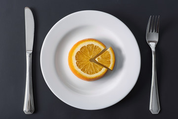 Orange slice on a white plate
