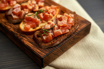 bruschetta with delicious fish on a cream cushion with capers and olive oil