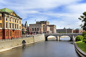 Stockholm, Sweden - Norrmalm district view from Old town quarter Gamla Stan - Stromgatan street with Opera House and Norrbron bridge in the background - obrazy, fototapety, plakaty