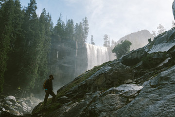 man hiking near water fall