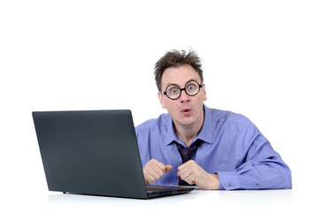 Surprised man programmer in round glasses with a laptop isolated on white background