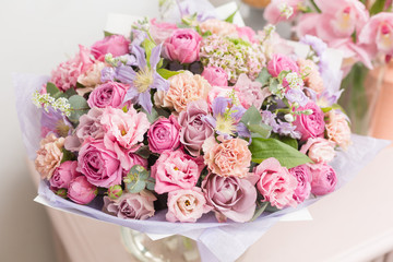 beautiful luxury bouquet of mixed flowers in glass vases. the work of the florist at a flower shop.