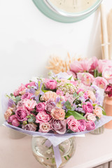beautiful luxury bouquet of mixed flowers in glass vases. the work of the florist at a flower shop.