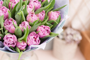 close-up. beautiful luxury bouquet of lilac tulips flowers on table. the work of the florist at a flower shop.