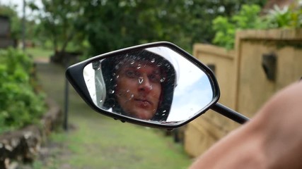 Guy with Girl are riding a scooter at tropics.