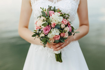 wedding bouquet in the hands of bride