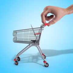 Fototapeta premium shopping cart in a hand 3d render over blue background
