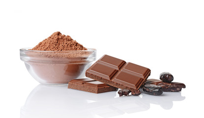 Close-up pieces of chocolate bar with cocoa beans and bowl of cocoa powder