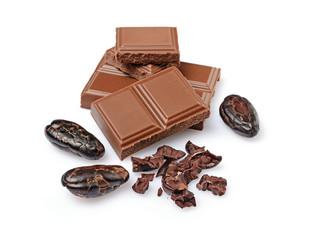 Close-up pieces of milk chocolate bar with cocoa beans