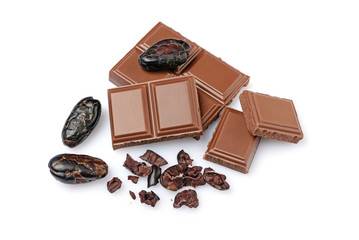 Close-up pieces of milk chocolate bar with cocoa beans