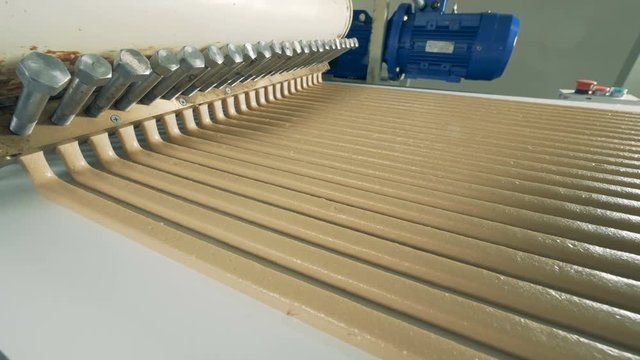 Top side-view of parallel lines of paste flowing from a paste-making machine