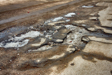 Old road. Concept  highway in huge pits and potholes  cloudy weather, sky in thick dark clouds. Symbol of  hard way