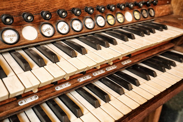 Old double piano keyboard with marked keys and pulls detail