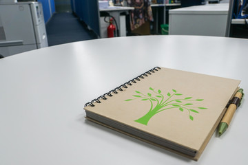 eco-friendly notebook with pen on office desk for note