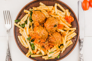 Macaroni with meatballs in tomato sauce - top view