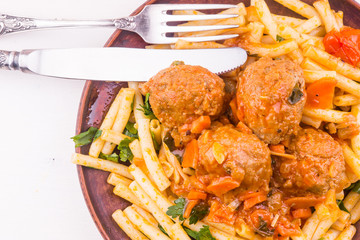 Macaroni with meatballs in tomato sauce - top view