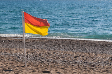 surf conditions, yellow red flag on the beach