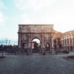 Fototapeta na wymiar The Arch of Titus alongside the Colosseum, Rome