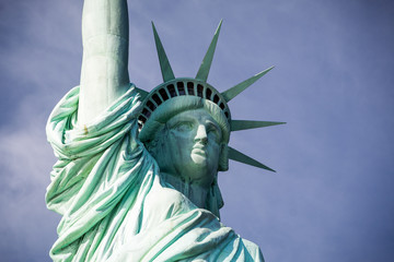 Fototapeta premium The statue of Liberty. Close-up, with some space on the right. Dramatic background.