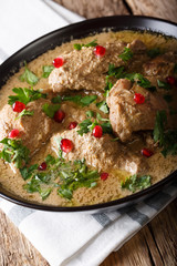 Satsivi walnut sauce with chicken close-up in a bowl. vertical